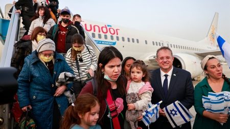 Passengers disembark from an airplane carrying Jewish immigrants fleeing the war in Ukraine, upon arrival in Israel’s Ben Gurion Airport, on March 6, 2022. (Photo by Menahem Kahana/AFP via Getty Images)