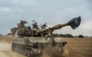 Israeli soldiers on a tank are seen near the Israel-Gaza border on October 9, 2023. (Photo by Ilia Yefimovich/picture alliance via Getty Images)