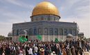 Palestinians wave Hamas flags as they gather in front of the Dome of the Rock inside Jerusalem's Al-Aqsa Mosque complex following Friday prayers during Ramadan, on April 22, 2022. (Photo by Ahmad Gharabli/AFP via Getty Images)